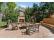 Inviting backyard with fireplace, patio, seating, and lush landscaping at 6202 Providence Country Club Dr, Charlotte, NC 28277