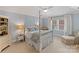 Comfortable bedroom featuring a four-poster bed, soft colors, and ample natural light at 6202 Providence Country Club Dr, Charlotte, NC 28277