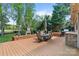 Spacious deck features an outdoor fireplace, dining set, grill and overlooks the lush green lawn at 6202 Providence Country Club Dr, Charlotte, NC 28277
