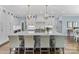 Spacious kitchen island with seating, white cabinets, and modern appliances with adjacent rooms visible at 6202 Providence Country Club Dr, Charlotte, NC 28277