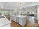 Open-concept kitchen featuring a large island, pendant lighting, modern appliances, and an adjacent dining area at 6202 Providence Country Club Dr, Charlotte, NC 28277