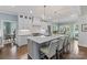 Stylish kitchen island with seating, white cabinetry, modern appliances, and beautiful pendant lighting at 6202 Providence Country Club Dr, Charlotte, NC 28277