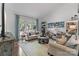 Bright living room with large windows, hardwood floors, and a serene backyard view with stylish furniture at 6202 Providence Country Club Dr, Charlotte, NC 28277