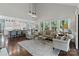 Open-concept living room and kitchen featuring hardwood floors, large windows, and a stylish breakfast bar at 6202 Providence Country Club Dr, Charlotte, NC 28277