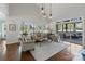 Spacious living room with hardwood floors, large windows overlooking the yard and a screened-in porch at 6202 Providence Country Club Dr, Charlotte, NC 28277
