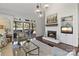 Bright living room featuring a brick fireplace and screened-in porch access, perfect for indoor-outdoor living at 6202 Providence Country Club Dr, Charlotte, NC 28277
