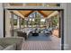 Inviting screened-in porch with vaulted wood ceiling, comfortable seating, and scenic outdoor views at 6202 Providence Country Club Dr, Charlotte, NC 28277