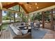 Inviting screened-in porch with vaulted wood ceiling, comfortable seating, and scenic outdoor views at 6202 Providence Country Club Dr, Charlotte, NC 28277