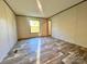 Bedroom features wooden floors and a window with a view of the backyard at 796 Old Wilkesboro Rd, Taylorsville, NC 28681