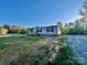 Charming single-story home featuring light blue siding, black shutters, and a wooden porch at 796 Old Wilkesboro Rd, Taylorsville, NC 28681