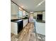 Modern kitchen with black appliances, white cabinets, and stylish wood-look flooring at 796 Old Wilkesboro Rd, Taylorsville, NC 28681