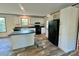 Modern kitchen with white cabinets, black appliances, and an island at 796 Old Wilkesboro Rd, Taylorsville, NC 28681