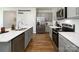 Modern kitchen featuring stainless steel appliances, gray cabinets, white quartz countertops, and hardwood floors at 870 Two Brothers Ln, York, SC 29745