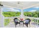 Covered balcony with seating and scenic views, perfect for relaxing outdoors at 9027 Mcdowell Creek Ln, Cornelius, NC 28031