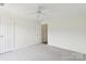 Bright and airy bedroom with neutral carpet, ample lighting, and a ceiling fan, offering a comfortable retreat at 9027 Mcdowell Creek Ln, Cornelius, NC 28031