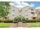 Attractive multi-story condo building featuring private balconies, well-maintained landscaping, and a welcoming entrance at 9027 Mcdowell Creek Ln, Cornelius, NC 28031