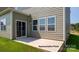 A concrete back patio area with sliding glass door and picture windows, perfect for relaxing and entertaining at 906 Two Brothers Ln, York, SC 29745