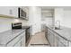 Modern kitchen featuring granite countertops, stainless steel appliances, and light gray cabinets at 906 Two Brothers Ln, York, SC 29745