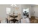 Bright dining room featuring a modern chandelier, dark wood floors, and an adjacent home office at 980 Bunker Trce, Rock Hill, SC 29730