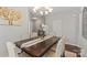 Elegant dining room with dark wood table, decorative centerpiece, and large windows for ample natural light at 980 Bunker Trce, Rock Hill, SC 29730