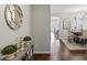 Inviting foyer with dark wood floors, decorative mirror, console table, and view of the dining area at 980 Bunker Trce, Rock Hill, SC 29730