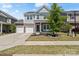 Charming two-story home with stone accents, manicured lawn, and a spacious two-car driveway in the daytime at 980 Bunker Trce, Rock Hill, SC 29730