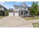 Charming two-story home with stone accents, a well-manicured lawn, and a spacious two-car driveway at 980 Bunker Trce, Rock Hill, SC 29730