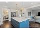 Spacious kitchen with a large center island, stainless steel refrigerator, and hardwood floors at 980 Bunker Trce, Rock Hill, SC 29730
