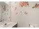 Half bathroom with a pedestal sink, decorative wall art, and a decorative mirror at 101 Canopy Ct, Mooresville, NC 28115