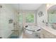 Modern bathroom featuring a soaking tub, double vanity, and a separate glass shower at 101 Canopy Ct, Mooresville, NC 28115