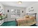 Cozy bedroom featuring a quilt-patterned bedspread and natural light from the window at 101 Canopy Ct, Mooresville, NC 28115