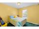 Cheerful yellow bedroom featuring bright natural light and a sunny atmosphere at 101 Canopy Ct, Mooresville, NC 28115
