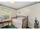 Bedroom features a charming wrought iron bed, desk, and green trim at 101 Canopy Ct, Mooresville, NC 28115