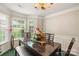 Dining room with marble table, chairs, and decorative chandelier at 101 Canopy Ct, Mooresville, NC 28115
