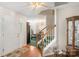 Entryway featuring staircase, door to dining room, and wood floors at 101 Canopy Ct, Mooresville, NC 28115