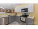 Well-lit kitchen featuring white cabinets, stainless steel appliances, and modern countertops at 101 Canopy Ct, Mooresville, NC 28115