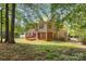 Spacious backyard with a wooden deck and mature trees at 10836 Fox Hedge Rd, Matthews, NC 28105