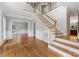 Inviting foyer featuring hardwood floors, staircase, and elegant trim at 10836 Fox Hedge Rd, Matthews, NC 28105