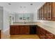 Classic kitchen featuring wood cabinetry, sleek appliances, and tile backsplash at 10836 Fox Hedge Rd, Matthews, NC 28105