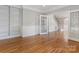 Bright living room featuring hardwood floors, built-in shelving, and classic trim at 10836 Fox Hedge Rd, Matthews, NC 28105