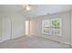 A carpeted bedroom features a ceiling fan and a double window at 10943 Winterbourne Ct, Charlotte, NC 28277