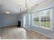Well-lit dining area featuring a fireplace, tiled floors, and modern lighting at 10943 Winterbourne Ct, Charlotte, NC 28277