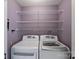 A laundry room features two machines and wire shelving at 10943 Winterbourne Ct, Charlotte, NC 28277