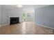 Open-concept living room featuring a fireplace, tile floors, and a seamless transition to the dining area at 10943 Winterbourne Ct, Charlotte, NC 28277