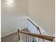 A stairwell features a wooden handrail and white risers at 10943 Winterbourne Ct, Charlotte, NC 28277