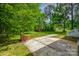 Spacious backyard with mature trees, brick BBQ, and patio area at 1090 Bowser St, Rock Hill, SC 29730