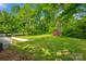 Spacious backyard with mature trees, green grass, and shed at 1090 Bowser St, Rock Hill, SC 29730