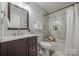 Modern bathroom features updated vanity, fixtures, marble-look tile, and bathtub with shower at 1090 Bowser St, Rock Hill, SC 29730