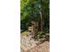 Bellingham Park sign nestled among tall trees, shrubs, and rocks with a brick walkway, enhancing its appeal at 110 Canary Ln # 3, Mooresville, NC 28115