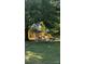Colorful playground equipment beneath a large shade tree with a bench, providing fun and relaxation at 110 Canary Ln # 3, Mooresville, NC 28115